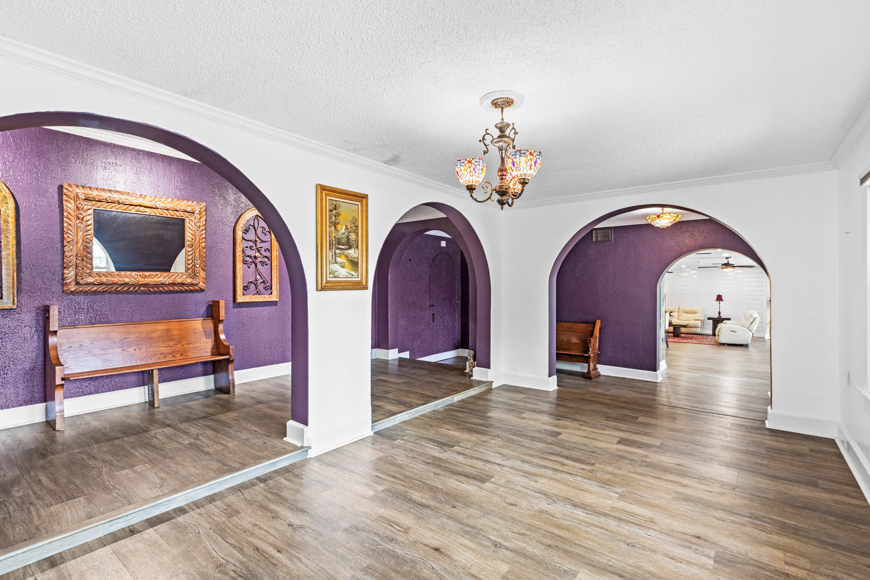 open room with white walls and purple hallway